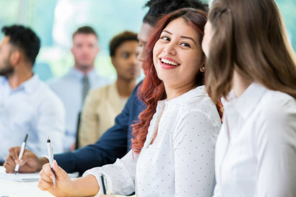 istock Young Hispanic female business student enjoys visiting before class 862545724