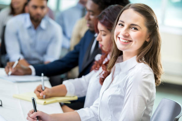 istock Young Hispanic female student smiles for camera during lecture 862545734