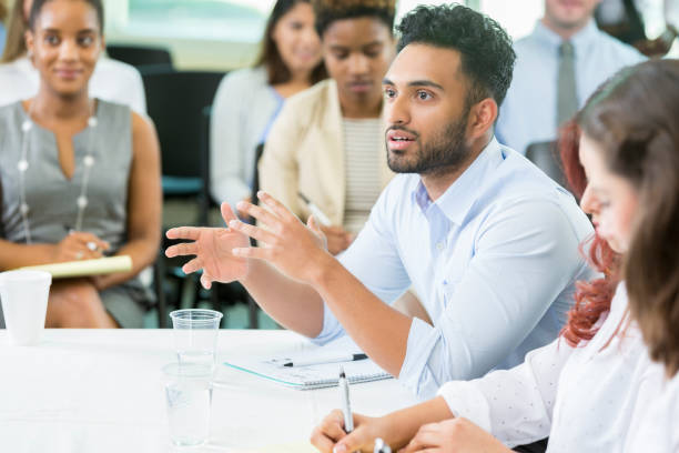 istock Young male business student poses question to lecturer 862545736
