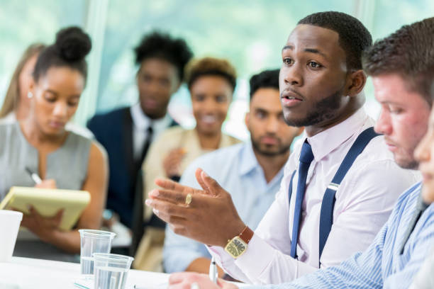 istock Young male business student poses question during lecture 862545764