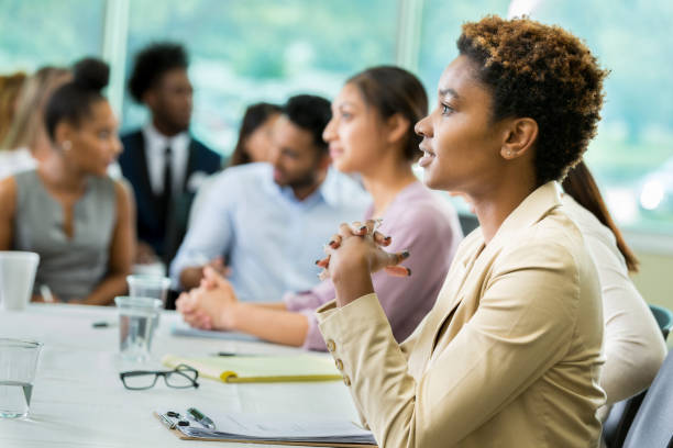 istock Young female business student sits enthralled during lecture 862545780