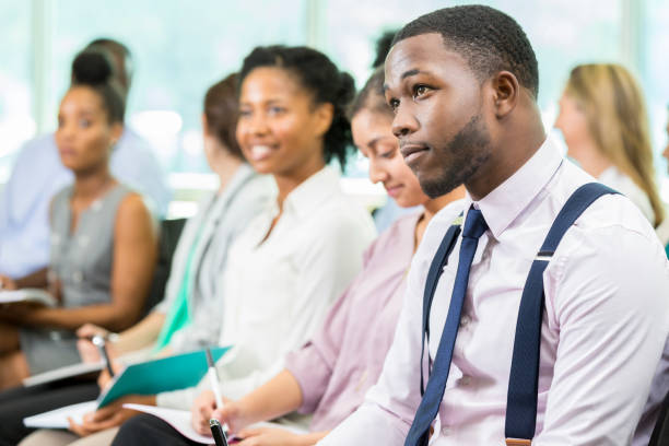 istock Attractive young male business student listens to class lecture 862545786