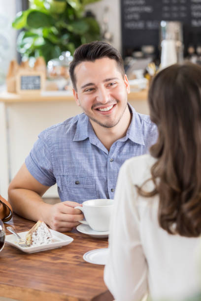 istock Young man talks with his date in a coffee shop 862546304