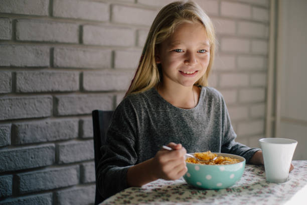istock Beautiful blond girl eating cereals for breakfast 862549904