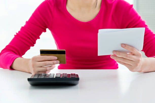 istock Woman hands holding bill and credit card 862553150