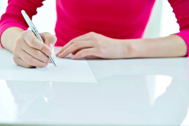 istock Woman writing on a paper 862553356