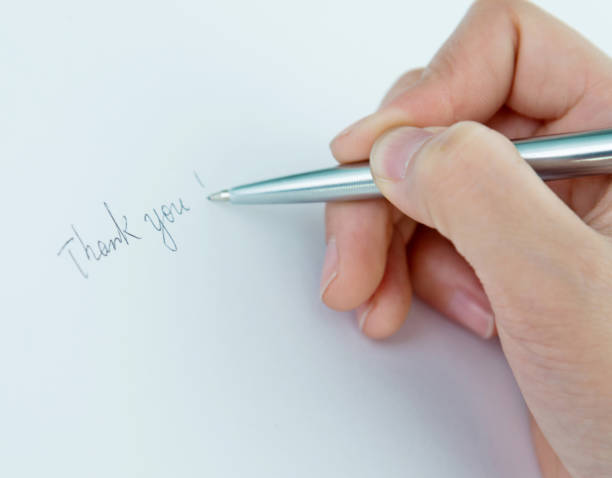 istock Woman writing thank you on paper 862553396