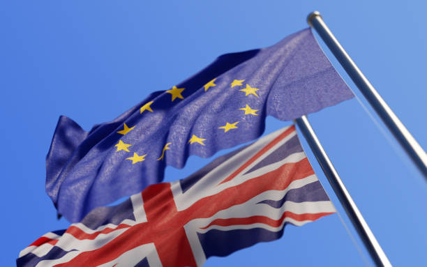 istock Europen Union And British Flags Waving With Wind On Blue Sky 862557764