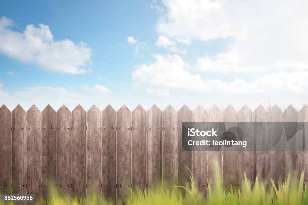 Wooden Fence On Green Garden Stock Photo - Download Image Now - Blue, Fence, Sky