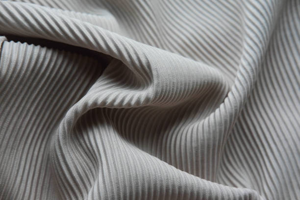 istock The fabric is laid out waves. Grey canvas material textiles. 862563520