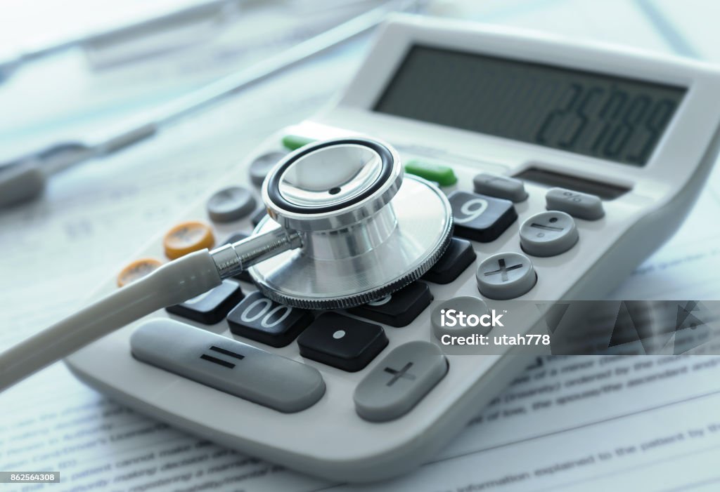 medical finance insurance health care costs or medical insurance savings concept. stethoscope on calculator with medical billing. Healthcare And Medicine Stock Photo