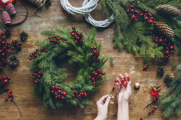 istock florist hands making Christmas wreath with fir branches 862570848