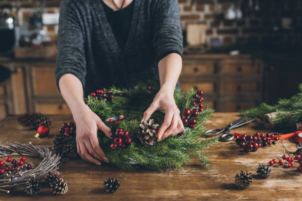 istock florist making Christmas fir wreath 862570980