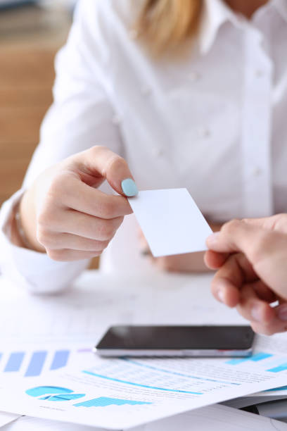 istock Female hand in suit give blank calling card 862574712