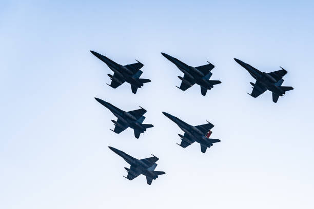 Six F18 Hornet jet fighters flying a blue sky day Madrid, Spain - October 12, 2017: Six F18 Hornet jet fighters flying in formation a blue sky day in Spanish National Day Army Parade. fa 18 hornet stock pictures, royalty-free photos & images