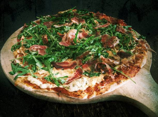 istock Homemade rustic pizza with tomato and arugula or rucula salad topping 862582422