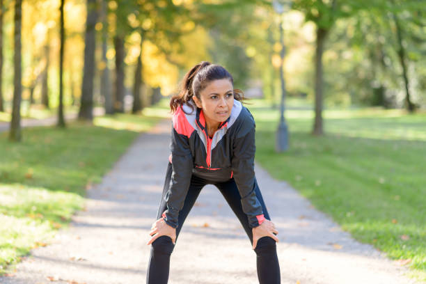 istock Smiling woman resting after jogging in park 862582440