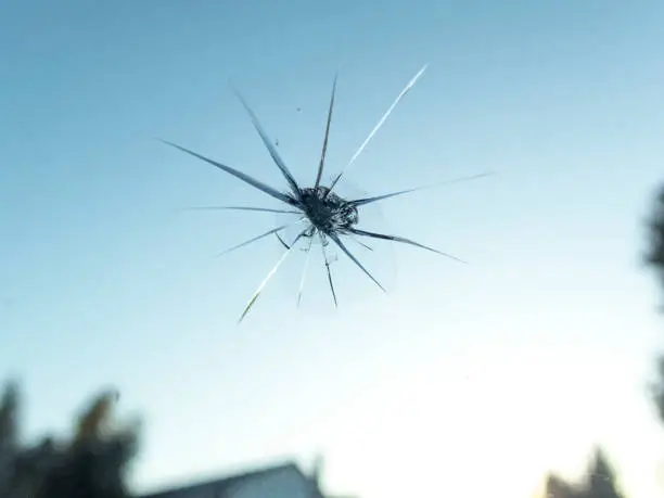 A POV view of a car windshield with a small rock chip as seen from the passenger seat.       Accidents