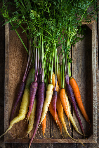 bunch of fresh rainbow carrots , top view