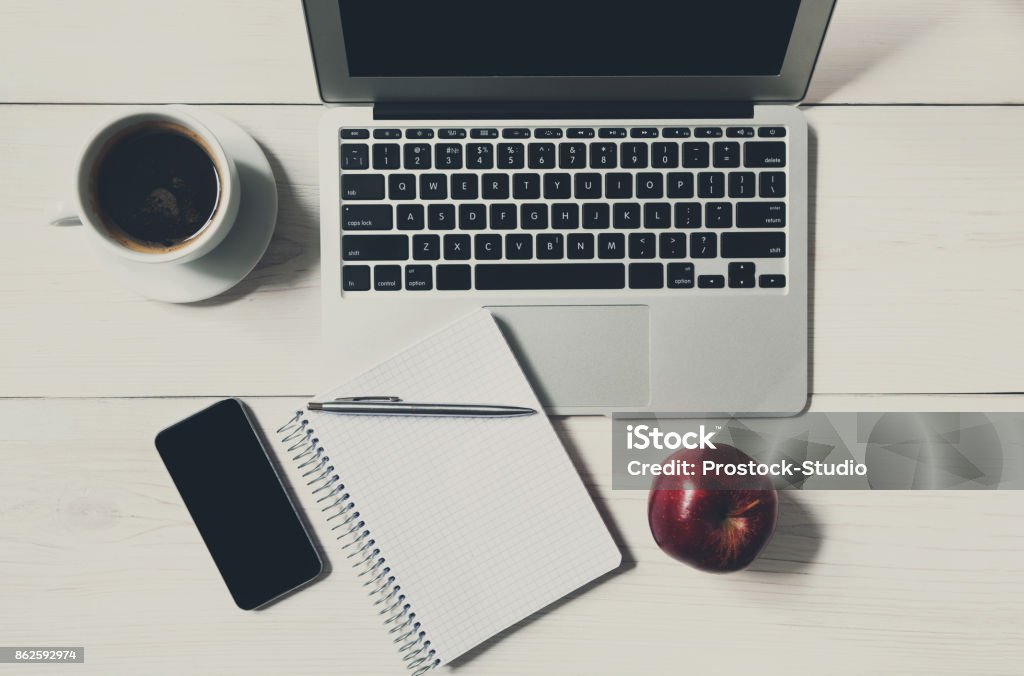 Diet concept, only apple at business lunch in the office Top view of white wooden table, americano coffee cup and apple near laptop and mobile Apple - Fruit Stock Photo