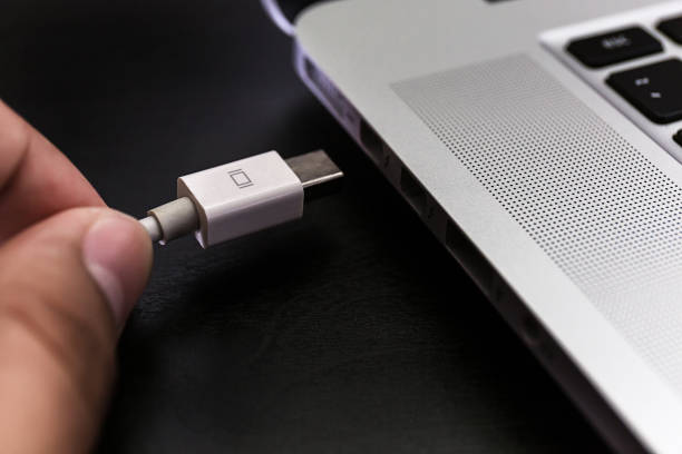 istock USB flash cards and thumb drive or stick Virtual memory storage with USB cable into slot  laptop computer 862596024