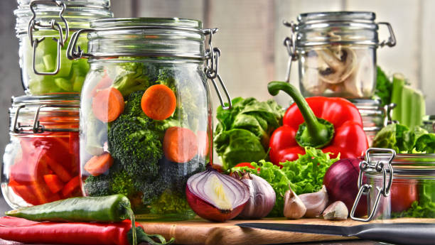 istock Jars with marinated food and raw vegetables on cutting board 862596064