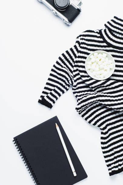 istock Striped women's blouse old camera and sketchbook on a white background 862597422