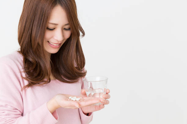 istock woman takes medicine capsules 862597758