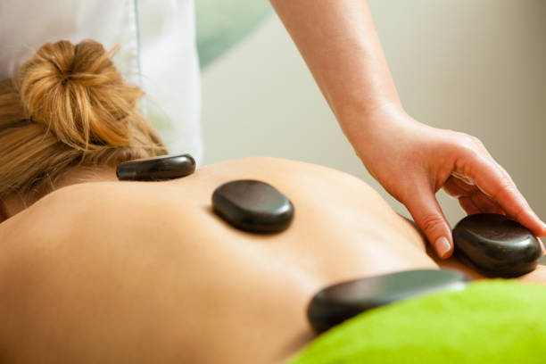 istock Massage with hot rocks stones in beautician 862600100