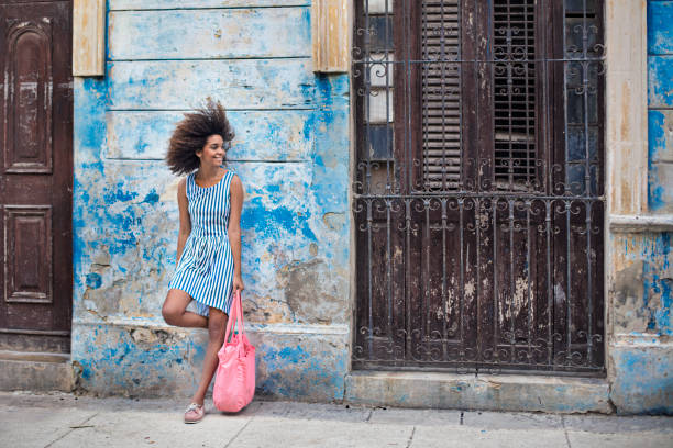 istock Smiling woman standing against weathered building 862604950