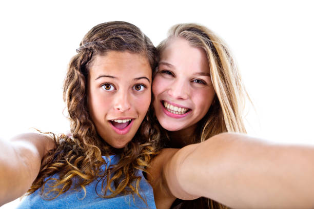 istock Two pretty girls take a smiling selfie 862611736