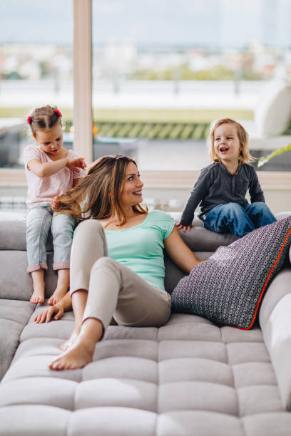 istock Happy mother having fun with her small kids at home. 862612044