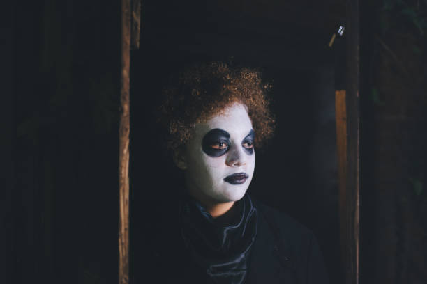 istock spooky boy with painted halloween mask in old barn 862612186