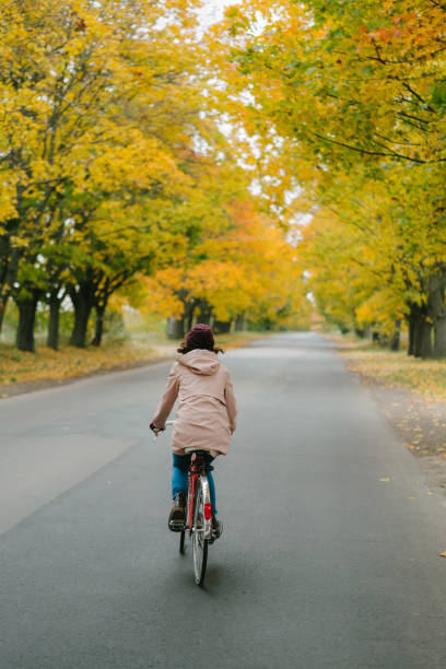 istock Woman riding on bicycle in  autumn 862616618