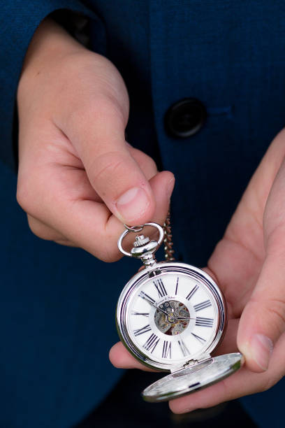 istock Young man holding open pocket watch 862616646
