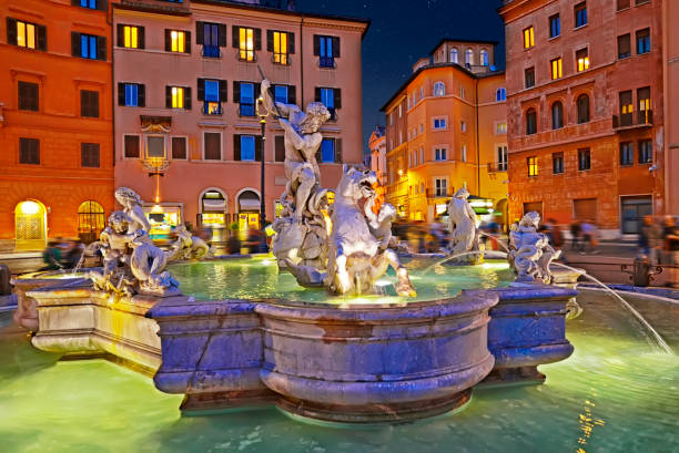 Amazing panoramic view   of the Fountain of Neptune in Piazza Navona at night. Rome, Italy stock photo