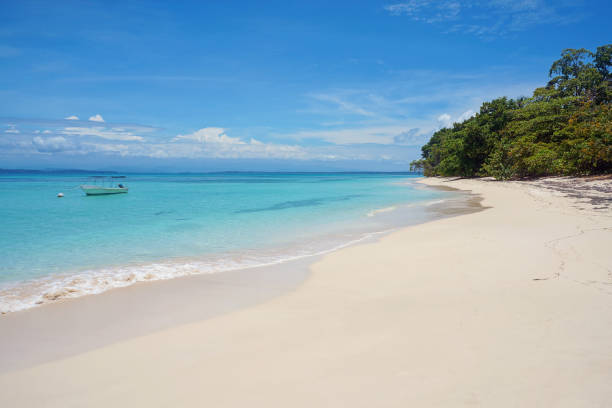 istock White sand beach with a boat on mooring buoy 862621200