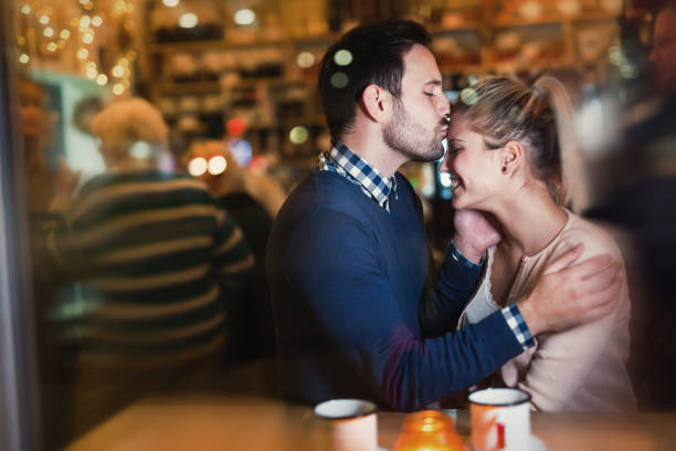 istock Young attractive couple on date in bar 862622442