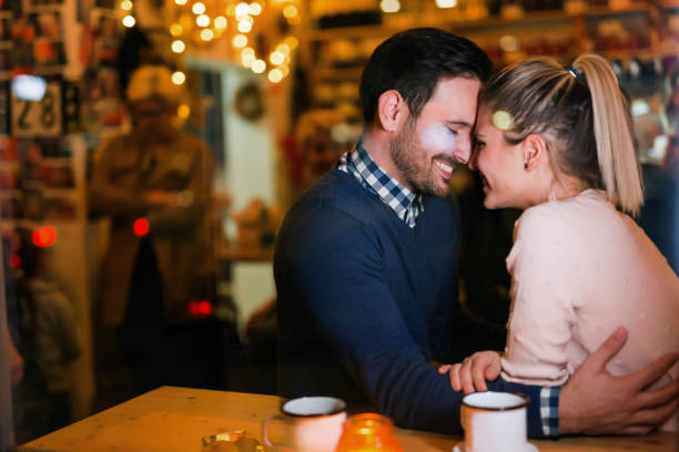 istock Young attractive couple on date in bar 862622630