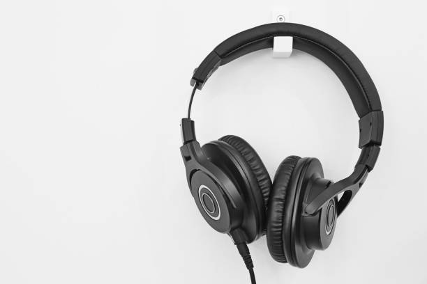 istock Headphone hanging on a white wall. Music background. Equipment 862625858