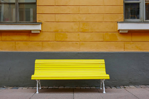 istock Yellow bench over an orange wall. Helsinki city center 862626014