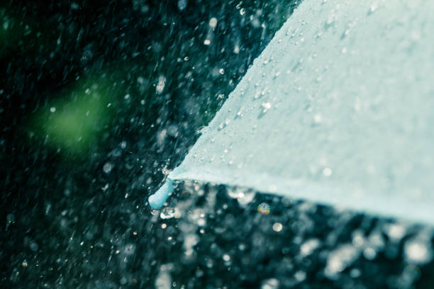 istock selective focus for close up a part of umbrella which has Rain drops falling , shallow DOF 862626030