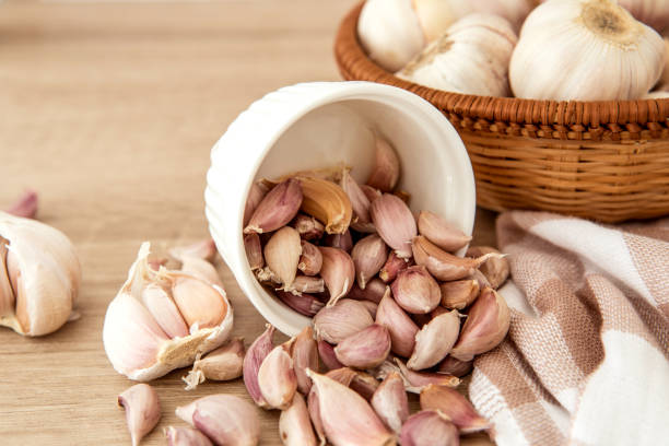 istock Close up  group of garlic on kitchen wooden table 862629310