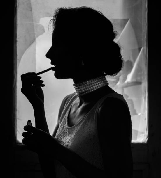 Close up of female face applying lip gloss near old window