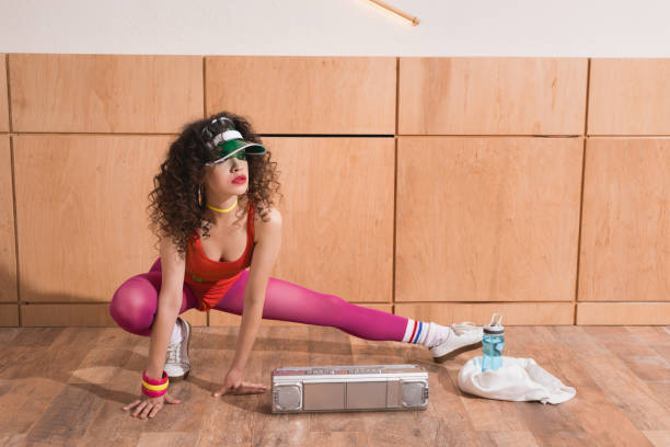woman stretching before training beautiful woman in stylish body suit stretching before training 80s aerobics stock pictures, royalty-free photos & images