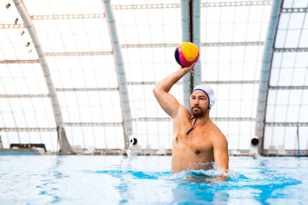 Water polo player in a swimming pool. Water polo player in a swimming pool. Man doing sport. water polo photos stock pictures, royalty-free photos & images