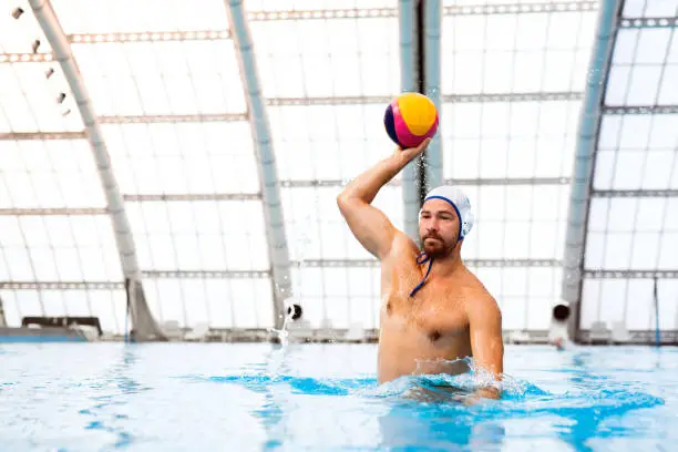 Photo of Water polo player in a swimming pool.