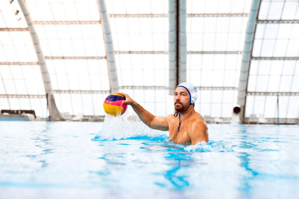 Water polo player in a swimming pool.