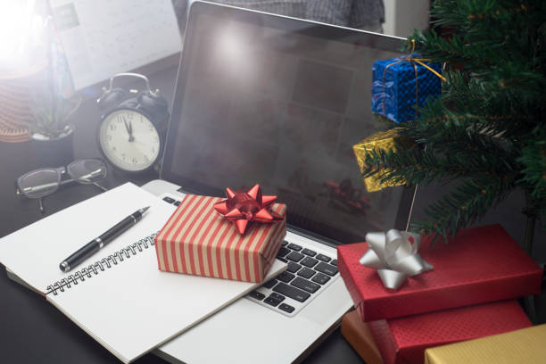 istock gift box with computer on desk. concept office christmas and happy new year. 862634570