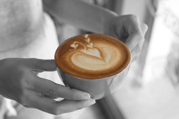 istock closeup hand holding coffee latte art cup. 862634612
